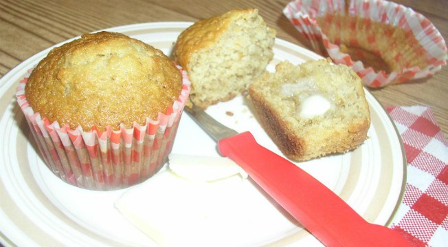 Oatmeal Muffins on a plate with butter and a red and white gingham napkin